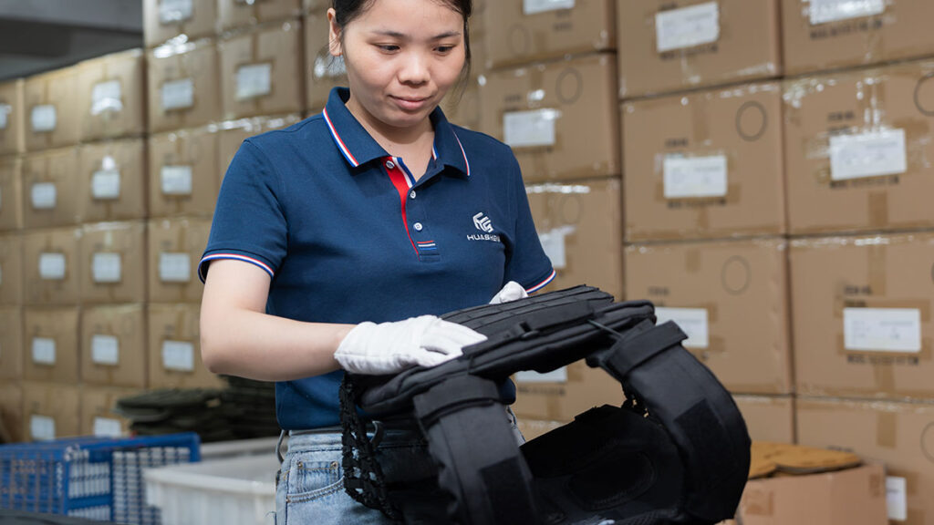 In-production quality control inspection of wholesale tactical vests (stitching and size check)